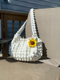 Crochet white bag with a sun flower